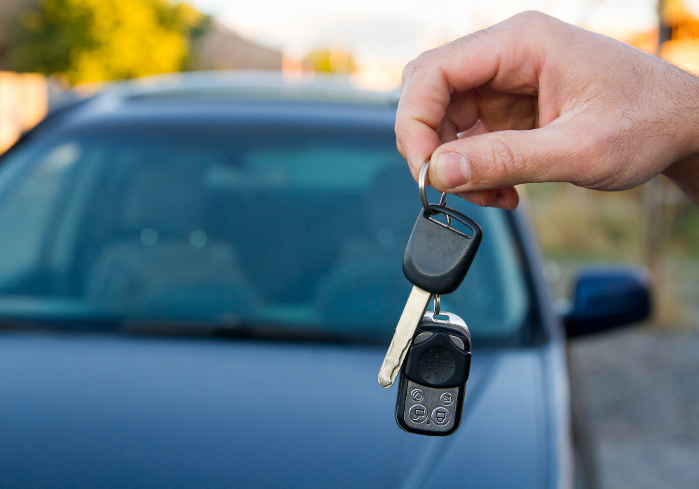 Auto locksmith holding new set of car keys